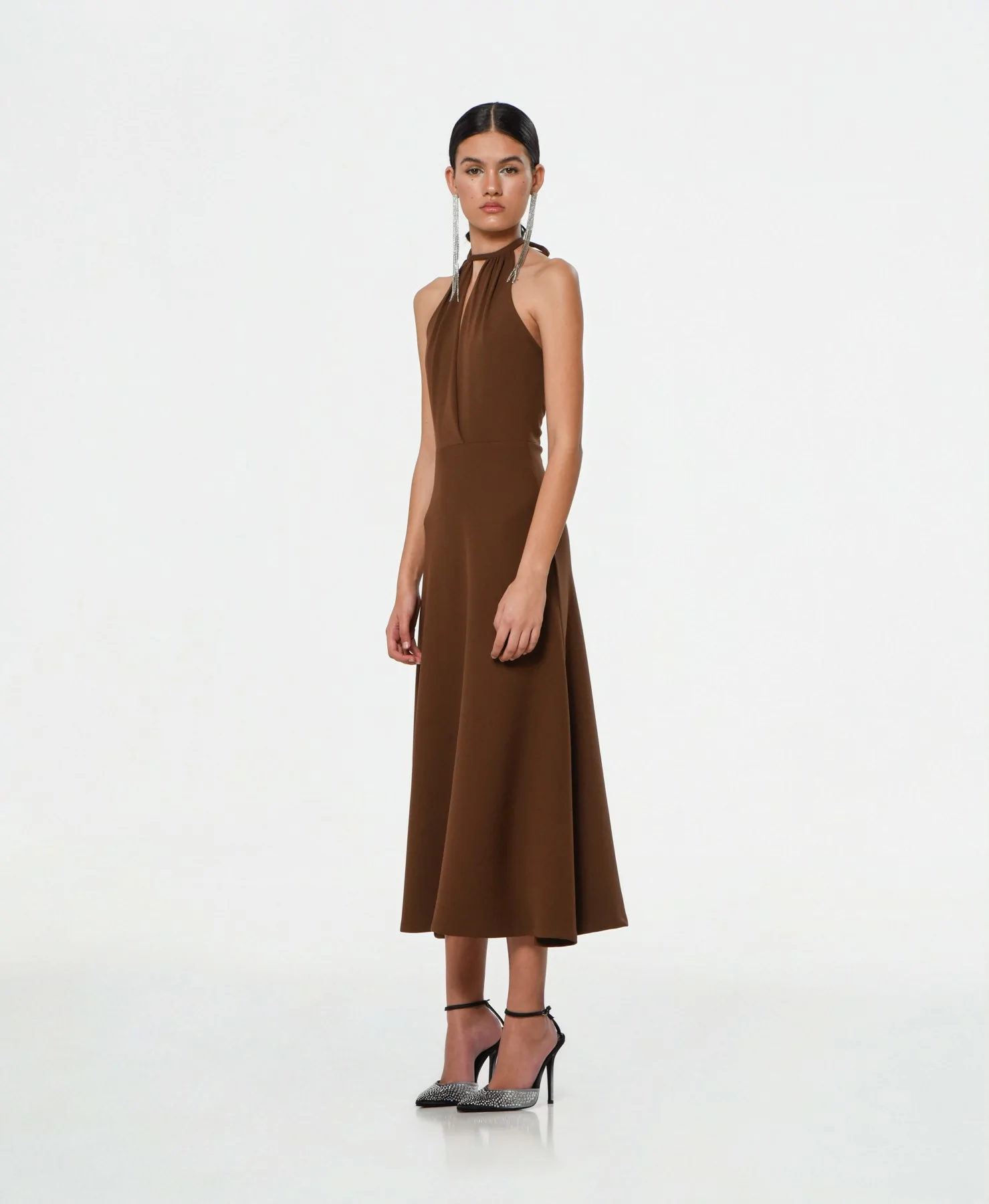 Brown midi dress with crossed halter neck, cape-style skirt and waist cut, side view