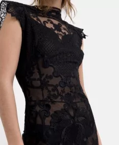 Side and macro detail of the flowing design and lace details of the black slip dress