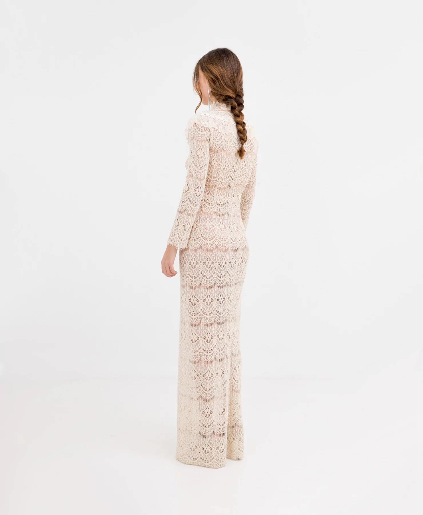 Back view of the beige lace dress with boho style, highlighting its delicate finish and fluidity.