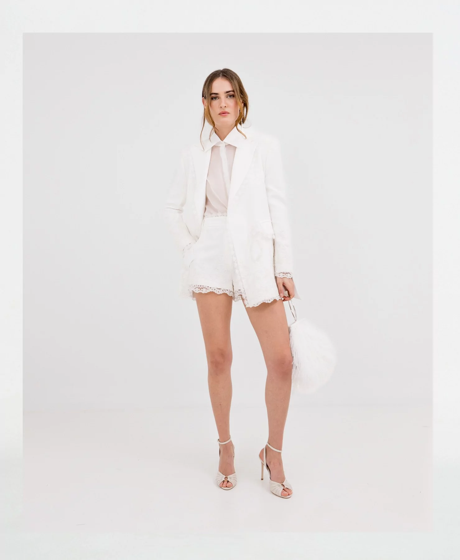 White blazer with lace in a formal outfit, fitted in white, combined with matching shirt and shorts