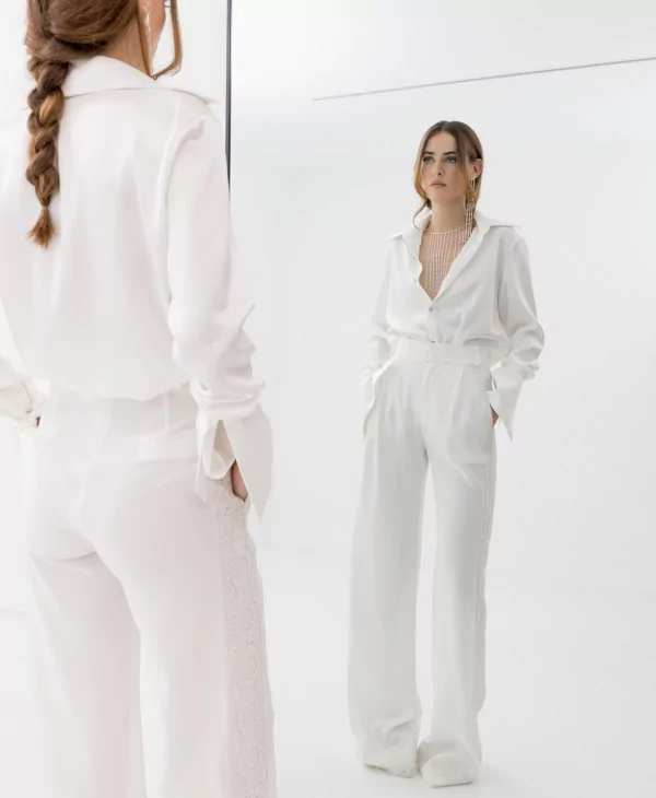 A great look for a woman with silk and lace trousers and a white silk blouse.